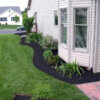 a picture of black mulch in a side garden